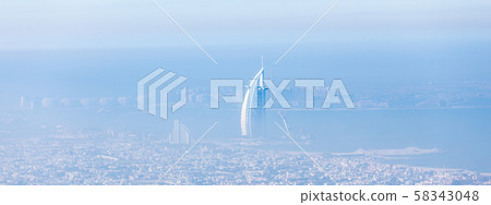 Skyline of Dubai beachfront with Burj Al Arab hotel on Jumeirah beach seen from Burj Khalifa 58343048