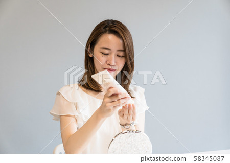 Young woman removing makeup 58345087