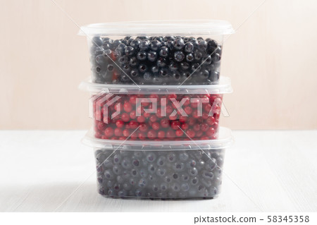 Berries laid out in containers and prepared for freezing and storage 58345358