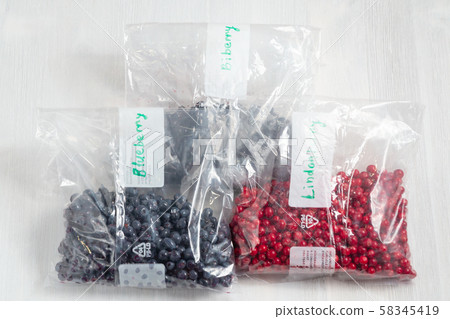 Berries laid out on a bags and prepared for freezing and storage, top view 58345419