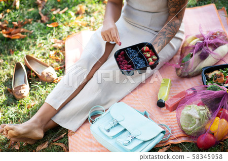 Top view of woman enjoying healthy picnic on nice warm day Top view of woman enjoying healthy picnic on nice warm day 58345958