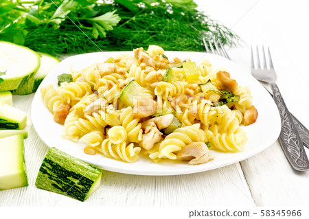 Fusilli with chicken and zucchini in plate Fusilli with chicken and zucchini in plate 58345966