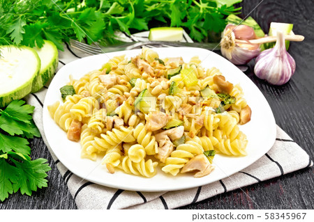 Fusilli with chicken and zucchini in plate Fusilli with chicken and zucchini in plate 58345967