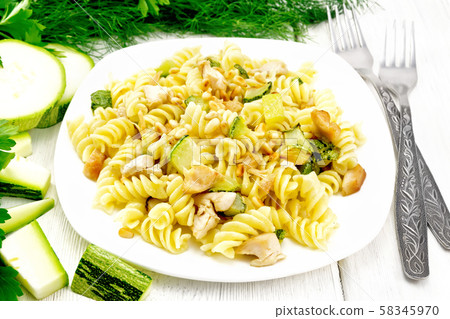 Fusilli with chicken and zucchini in plate Fusilli with chicken and zucchini in plate 58345970