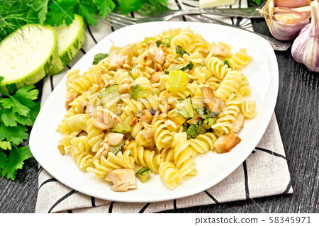 Fusilli with chicken and zucchini in plate Fusilli with chicken and zucchini in plate 58345971