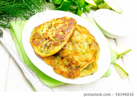 Pancakes of zucchini on white board Pancakes of zucchini on white board 58346816
