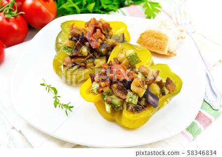 Pepper stuffed with vegetables in plate on board 58346834
