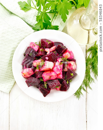 Salad of beets and potatoes in plate on board top 58346843