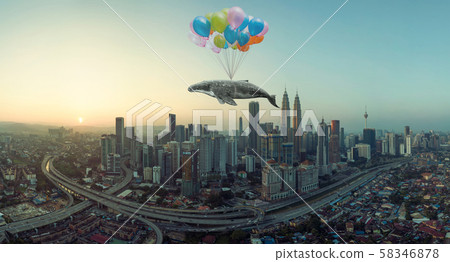 Whale floats in the air above the clouds with bunch of colorful balloons . 58346878