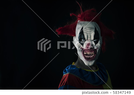 scary evil clown with a bloody mouth 58347149