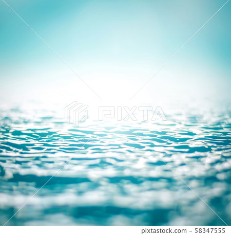 Blurred nature background of wavy water surface in cyan blue color tone with vignette 58347555