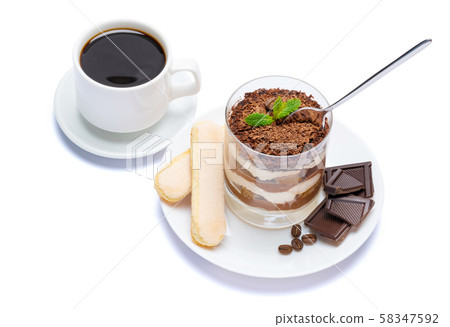 Classic tiramisu dessert in a glass, cup of coffee and pieces of chocolate on white background with Classic tiramisu dessert in a glass, cup of coffee and pieces of chocolate on white background with 58347592