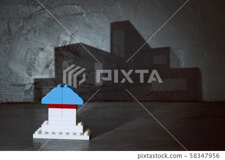 Plastic building blocks with modern house shadow . Creative and ideal concept . Concrete interior background . Plastic building blocks with modern house shadow . Creative and ideal concept . Concrete interior background . 58347956