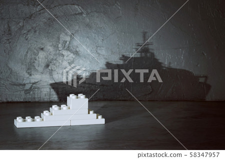 Plastic building blocks with ship shadow . Creative and ideal concept . Concrete interior background . Plastic building blocks with ship shadow . Creative and ideal concept . Concrete interior background . 58347957