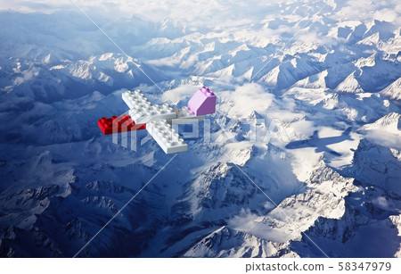 Plastic building blocks with aeroplane shadow , top angle view ice mountain landscape . Creative and ideal concept . 58347979