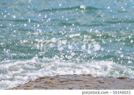 Splashes and drops of water on a blue sea Splashes and drops of water on a blue sea 58348031
