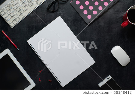 Wooden black office desk table with notebook, keyboard and cup of coffee. Blank notebook page for input the text in the middle. Top view Wooden black office desk table with notebook, keyboard and cup of coffee. Blank notebook page for input the text in the middle. Top view 58348412