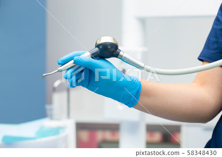 Close-up teeth airflow tool in the hand. 58348430