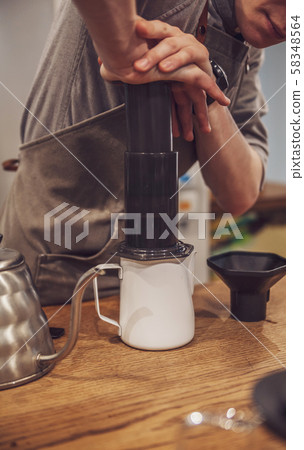 Barista is making alternative coffee with 58348564