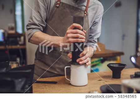 Barista is making alternative coffee with 58348565