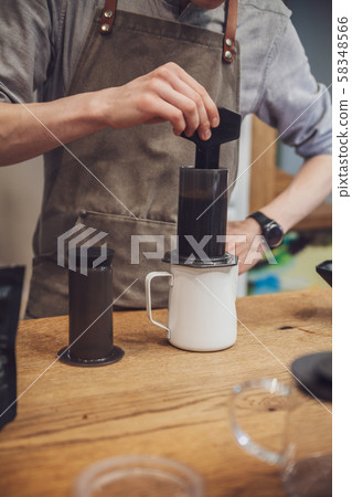 Barista is making alternative coffee with 58348566