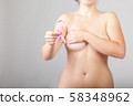 Beautiful Nude woman hold pink ribbon in hand 58348962