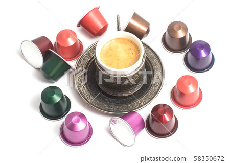 delicious coffee capsules around coffee cup 58350672
