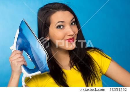 Houseworks, woman with pile of clothes for ironing Houseworks, woman with pile of clothes for ironing 58351262
