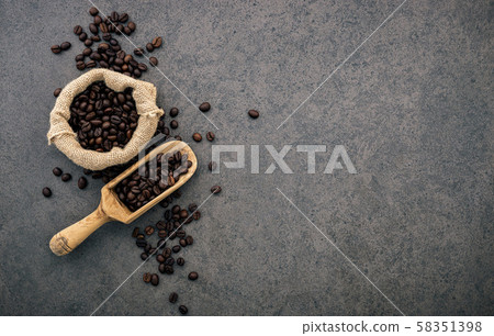 Dark roasted coffee beans on stone background. Top 58351398