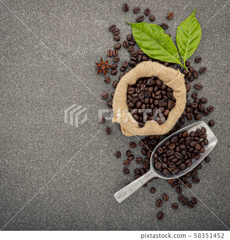 Dark roasted coffee beans on stone background. Top Dark roasted coffee beans on stone background. Top 58351452