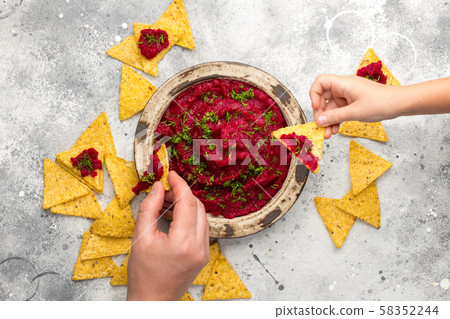 Beetroot hummus in a bowl on gray board Beetroot hummus in a bowl on gray board 58352244