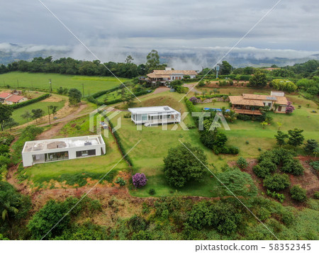 Aerial view of luxury villa in tropical valley Aerial view of luxury villa in tropical valley 58352345