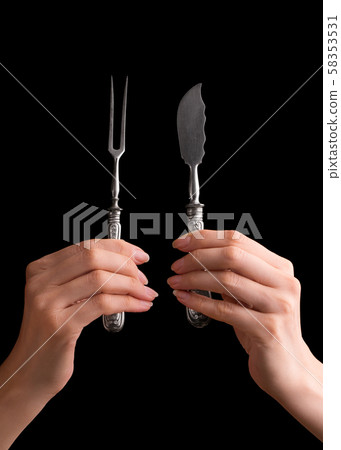 Cutlery in a girl's hand. 58353531