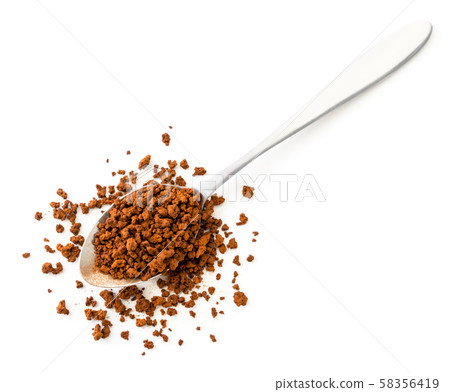 Spoon of instant coffee is scattered on a white Spoon of instant coffee is scattered on a white 58356419