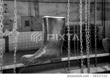 Rubber boots in mining dressing room Rubber boots in mining dressing room 58357132