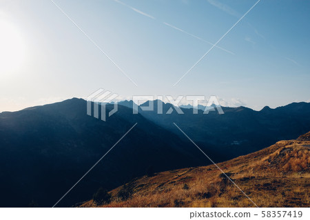 Beautiful alpine landscape with mountain silhouettes in the Col de la Lombarde during the sunset Beautiful alpine landscape with mountain silhouettes in the Col de la Lombarde during the sunset 58357419