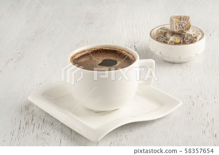 A cup of Turkish coffee and delight on a wooden A cup of Turkish coffee and delight on a wooden 58357654