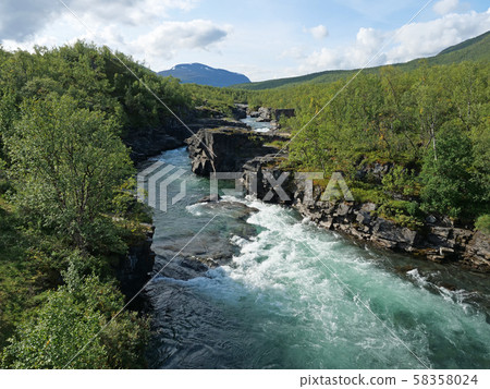 Lapland nature landscape. Abisko blue river canyon carved in the limestone and granite by glacial Lapland nature landscape. Abisko blue river canyon carved in the limestone and granite by glacial 58358024