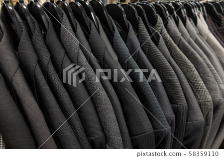 Male Mens Gray Suits on Hangers on a Shop Wardrobe 58359110