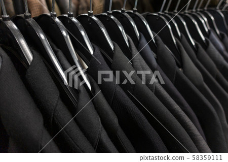 Male Mens Dark Suits on Hangers on a Shop Wardrobe or Closet Rail 58359111