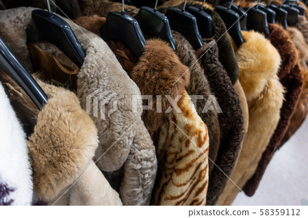 Rail of Secondhand Fur Coats For Sale in a Thrift Store 58359112