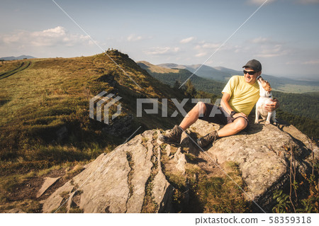 Alone tourist sitting on the edge of the cliff 58359318