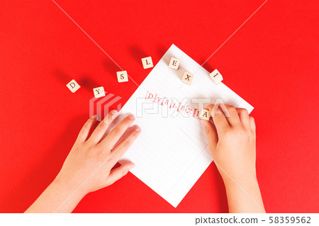 Dyslexia word stamped on notebook page on red Dyslexia word stamped on notebook page on red 58359562
