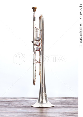 Trumpet instrument on wooden table. Trumpet instrument on wooden table. 58360014