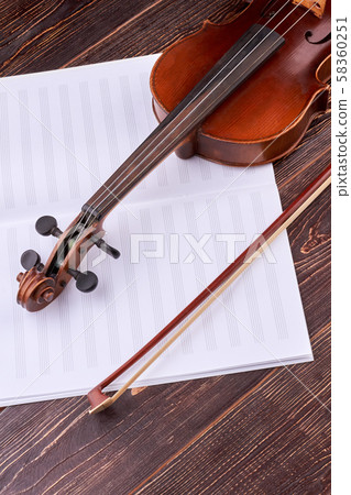 Violin and music notes book, vertical image. 58360251