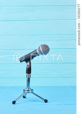 Microphone on blue wooden background. Microphone on blue wooden background. 58360277