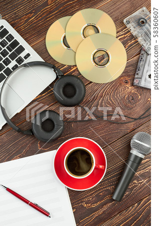 Wooden background with audio devices. Wooden background with audio devices. 58360607