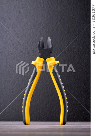 Plier with black and yellow handle. Plier with black and yellow handle. 58361077