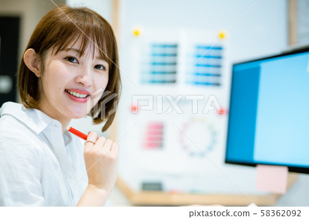 A woman in her 20s who works toward a computer display A woman in her 20s who works toward a computer display 58362092