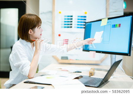 A woman in her 20s who works toward a computer display A woman in her 20s who works toward a computer display 58362095